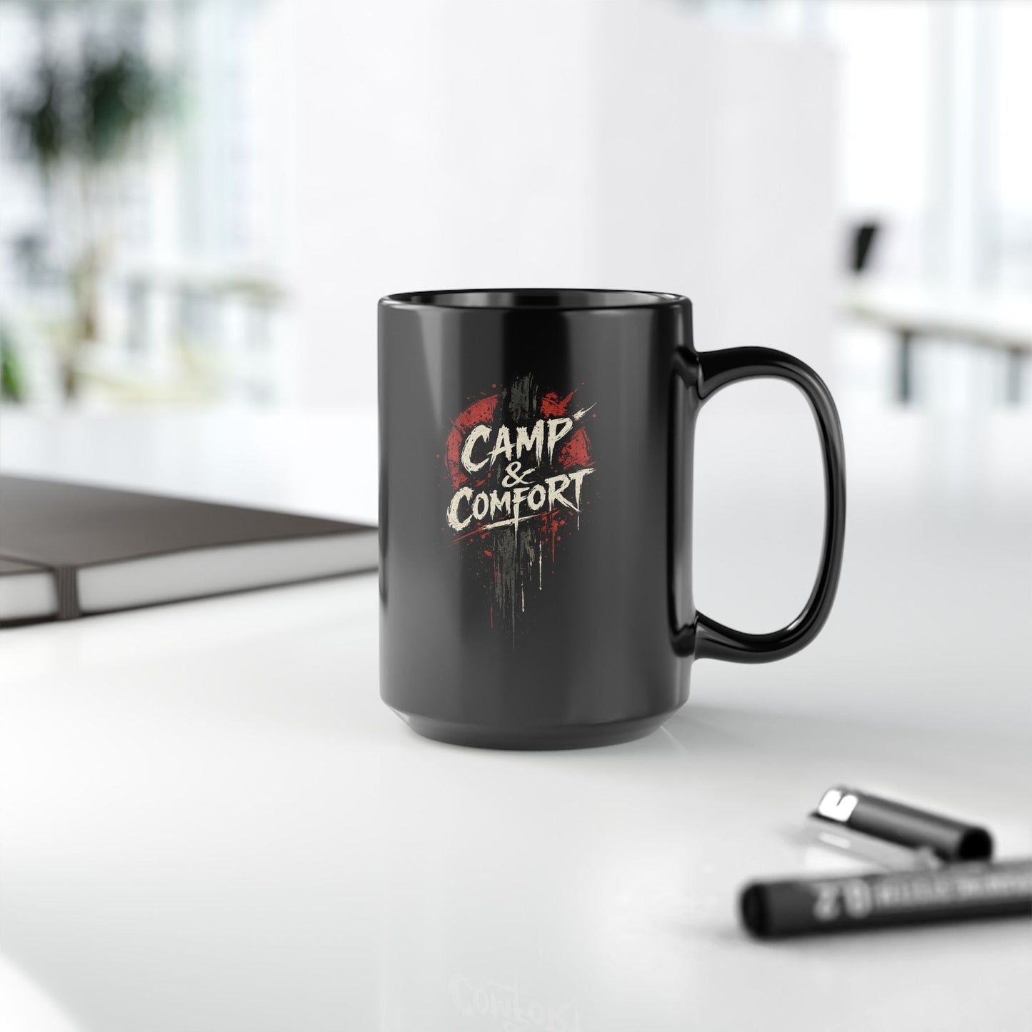 "The Camp & Comfort Splatter Mug Official Sweepstakes prize, featuring a black ceramic finish with a red and white distressed 'splatter' logo design."