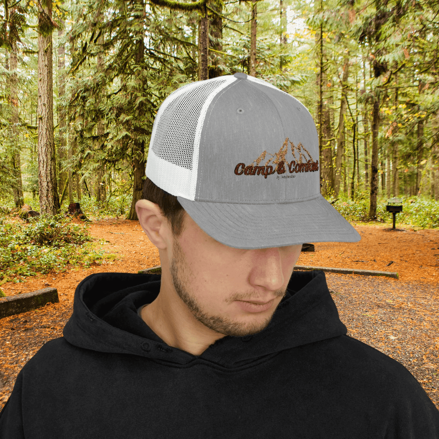 A display of Adventure Hats and Beanies including a leather-patch trucker hat and a thick knit beanie on a rustic wooden background.
