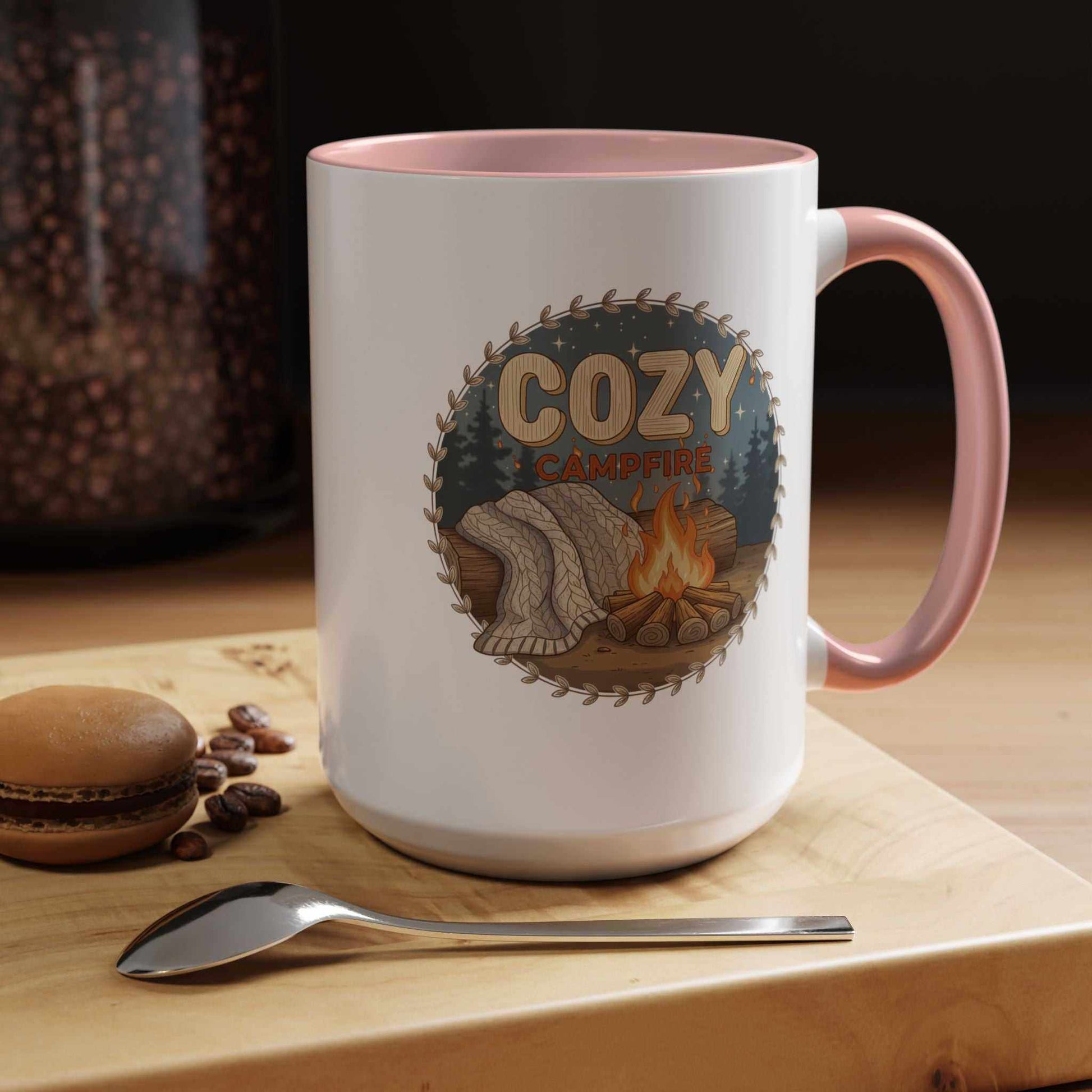 A Cozy Campfire Mug in speckled ceramic with a pink rim, filled with hot coffee and sitting on a wooden surface