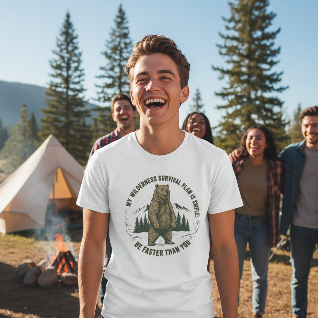 "A man wearing a Camp & Comfort wilderness survival plan tee while standing near a campfire in a pine forest."
