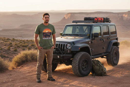 Overland More Adventure Tee graphic t-shirt by Camp & Comfort, featuring a minimalist mountain and adventure rig design. Premium cotton camping apparel for overlanding and off-road enthusiasts.