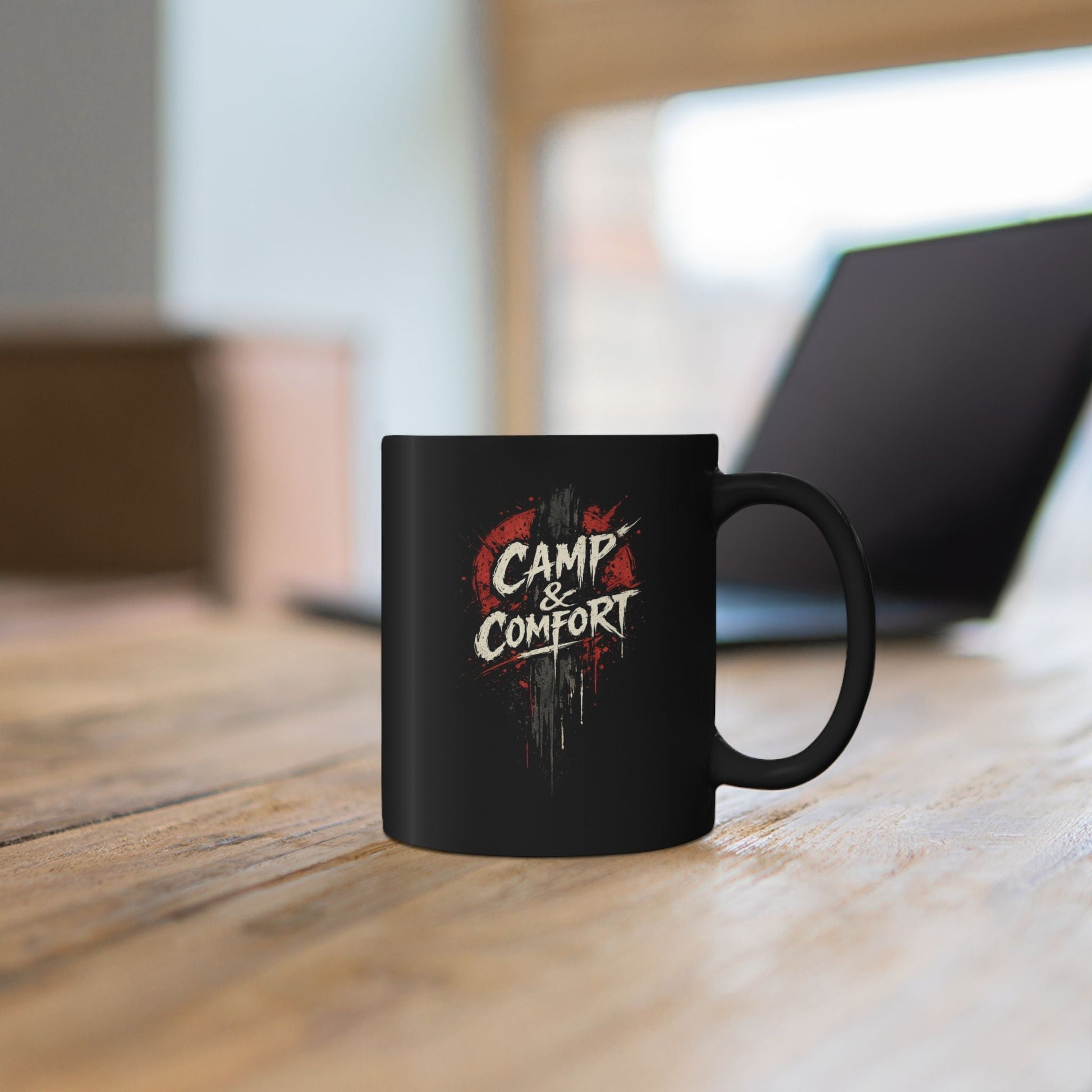 "The Camp & Comfort Splatter Mug Official Sweepstakes prize, featuring a black ceramic finish with a red and white distressed 'splatter' logo design."