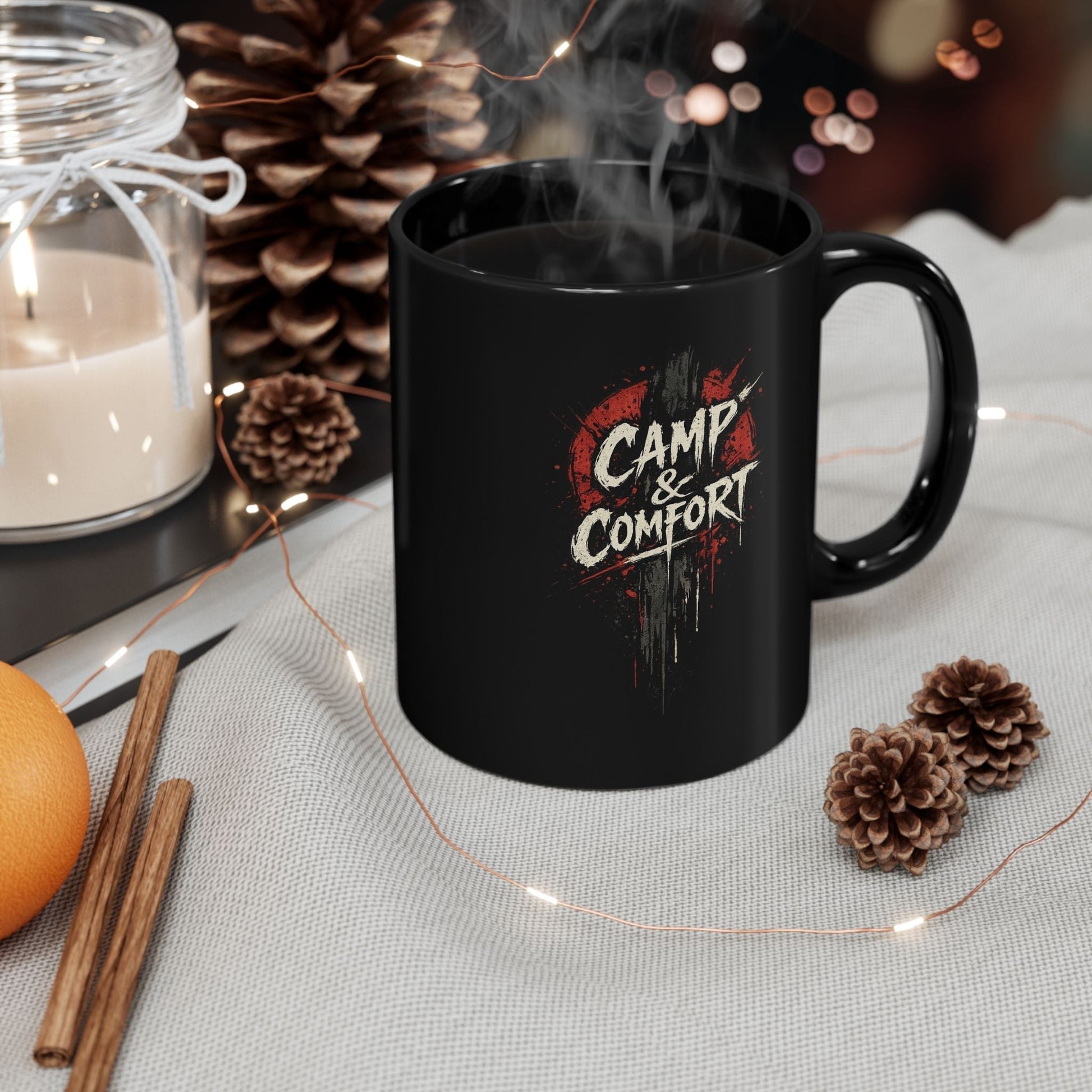 "The Camp & Comfort Splatter Mug Official Sweepstakes prize, featuring a black ceramic finish with a red and white distressed 'splatter' logo design."